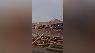 Debris scattered around damaged buildings after tornado hits Texas