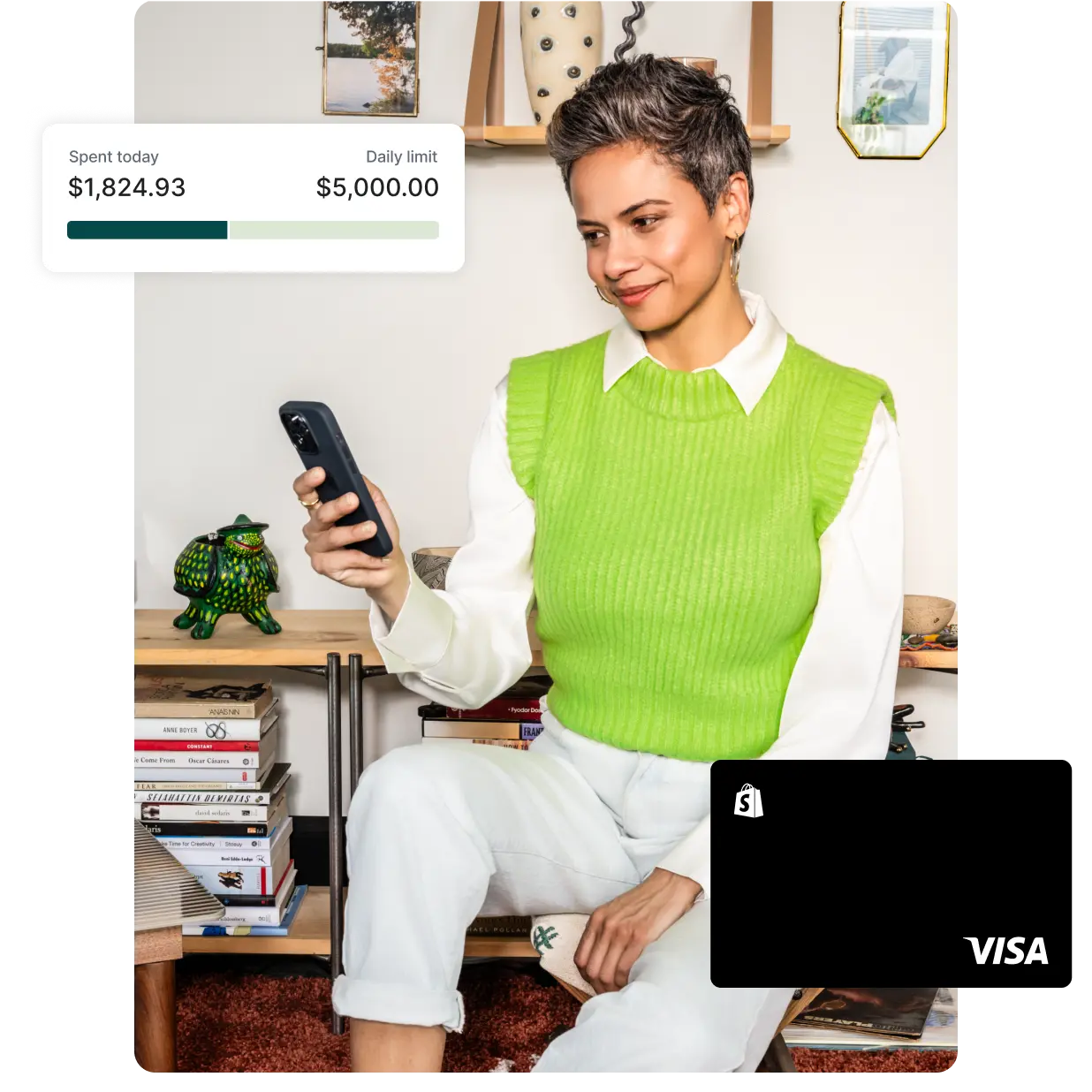 A Spanish woman wearing a bright green vest smiles while looking at her Shopify Balance account on her mobile device.
