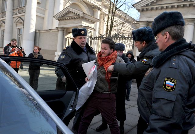 Police detain a gay rights activist in St. Petersburg on Thursday.