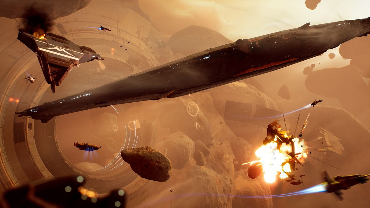 Several spaceships careen between asteroids, mid-battle, torpedoes visibly flying. One of the ships on the bottom right is in the midst of exploding