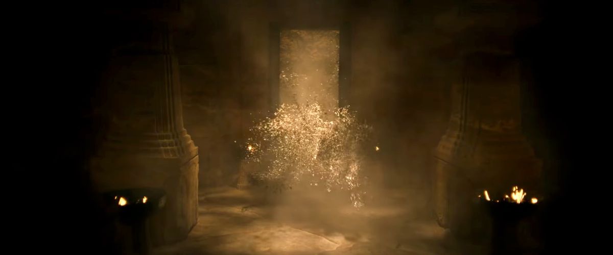 A swarm of what looks like moths fountains through a doorway into a dark room with squared stone pillars in the trailer for season 2 of The Lord of the Rings: The Rings of Power