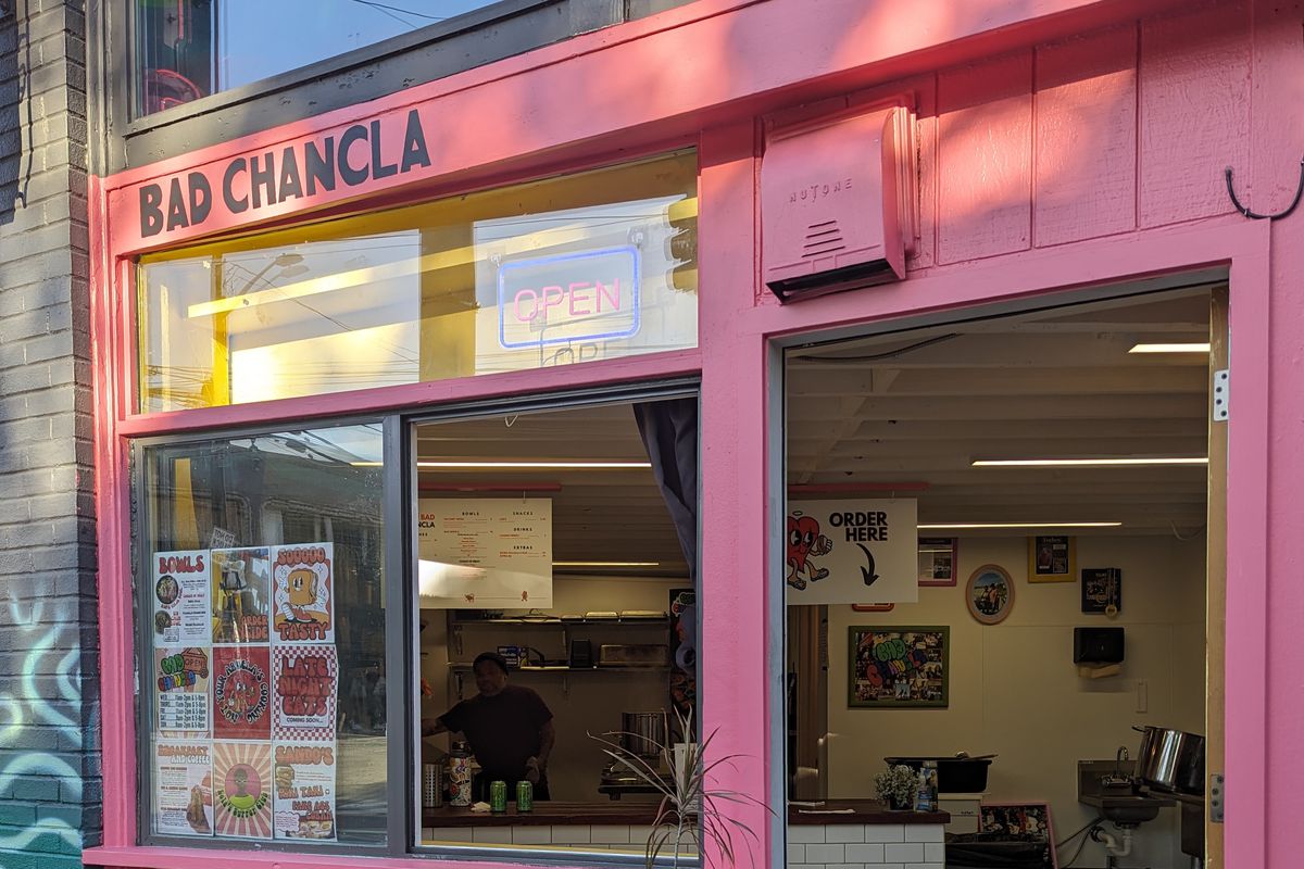 A pink storefront with an open door, reading “Bad Chancla” above the window.