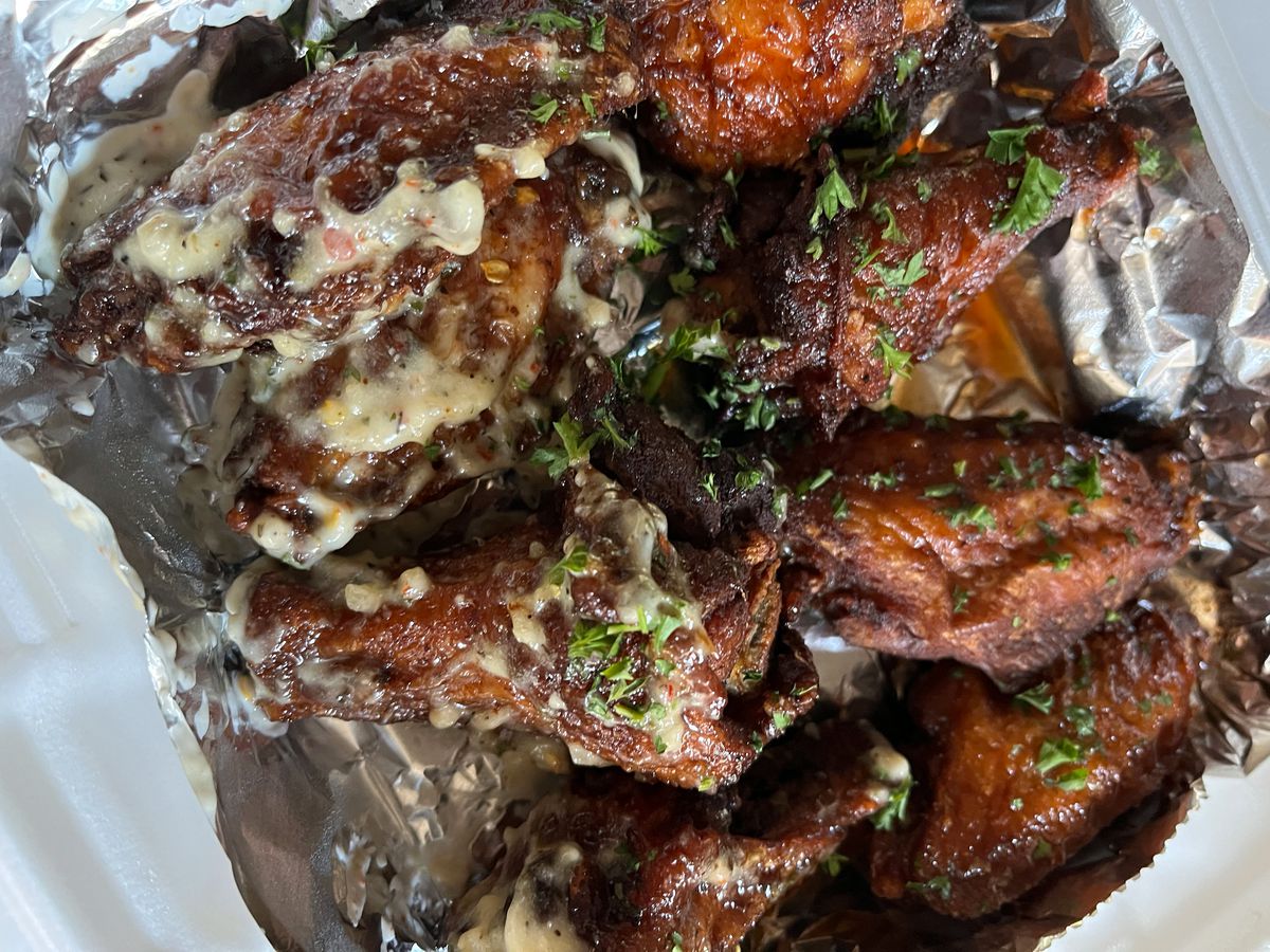 Messy wings with sauce in foil.