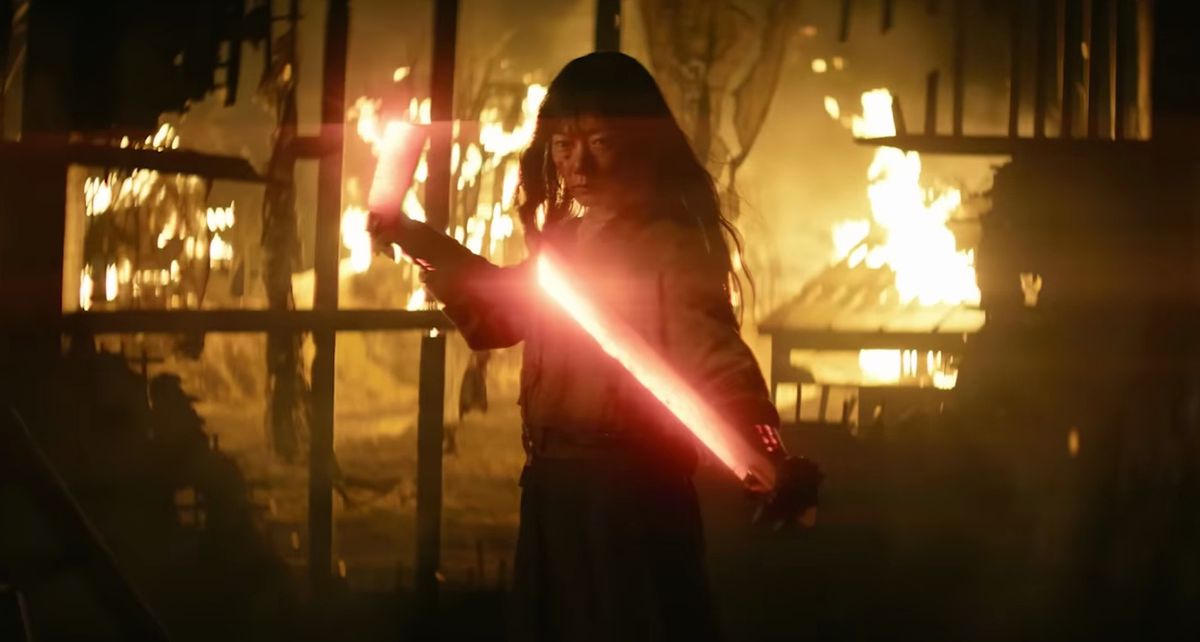 Doona Bae holds two lightsaber-looking swords up in the trailer for Rebel Moon 2: The Scargiver
