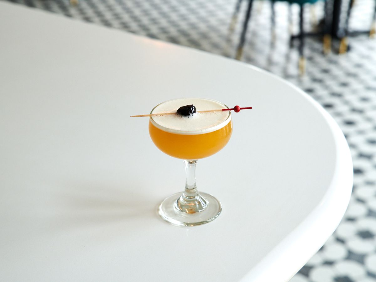 A picture of a Hotel Nacional daiquiri at Palomar, which arrives up, in a coupe glass, with a cherry