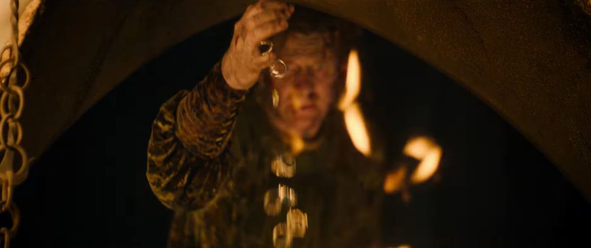 A cascade of gold rings falls from Celebrimbor’s hand in The Lord of the Rings: The Rings of Power. 