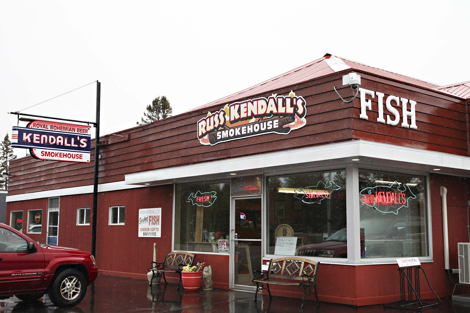 The exterior of a red building with a sign that says “Russ Kendall’s” and another one that says “FISH.”