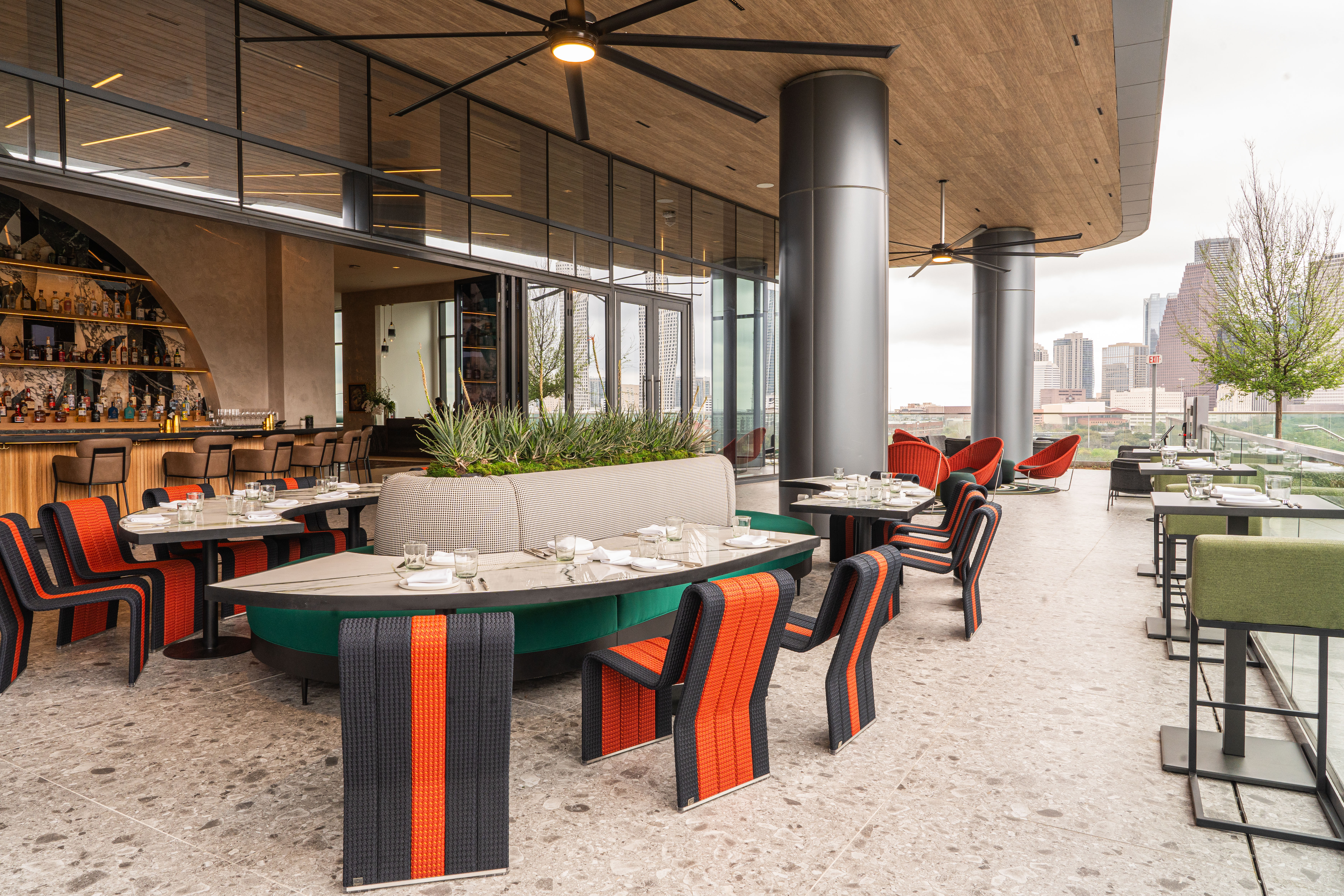 Patio tables at Sol7 with views of the Downtown skyline.