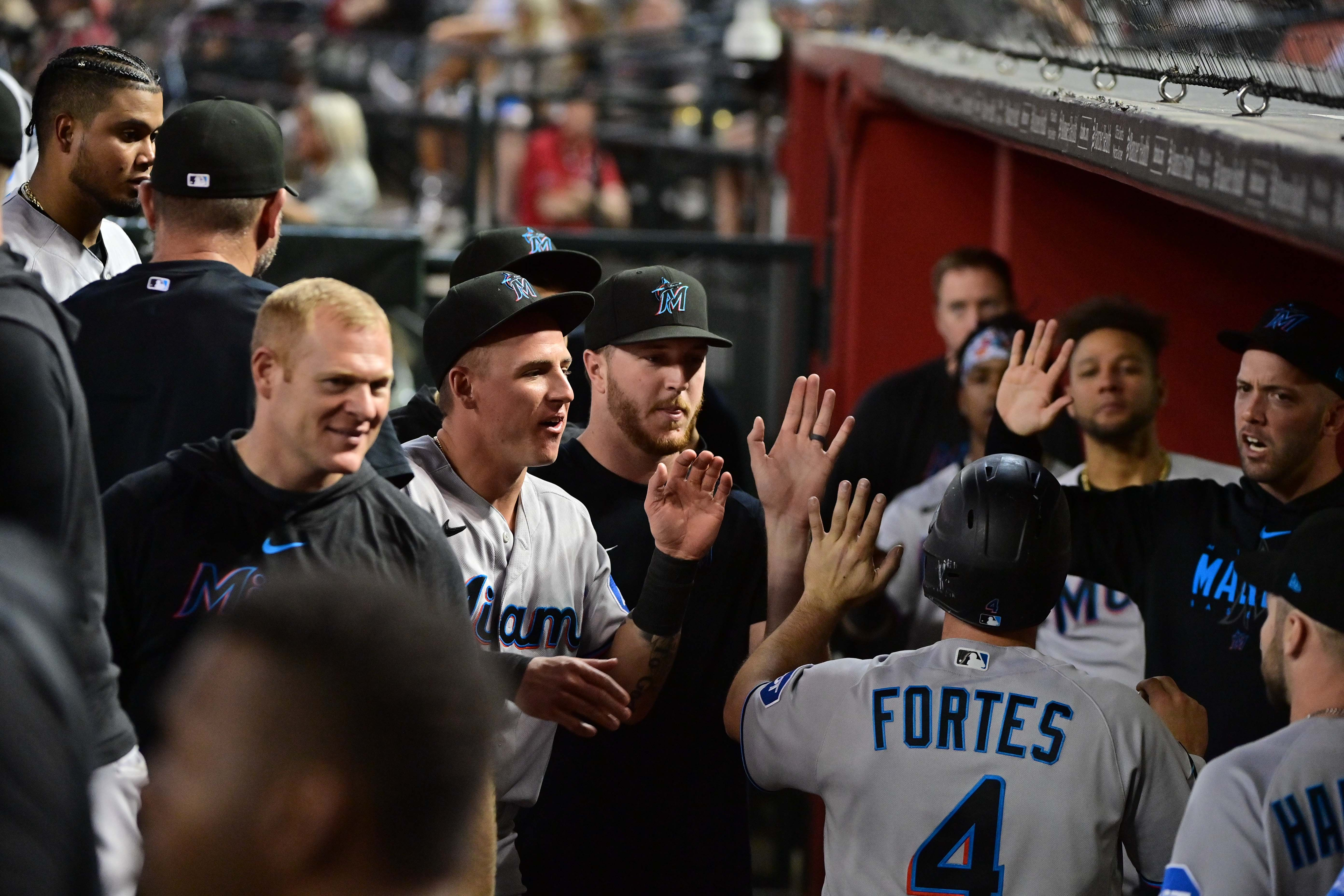 Miami Marlins catcher Nick Fortes (4) celebrates with teammates after scoring in the fifth inning against the Arizona Diamondbacks at Chase Field.