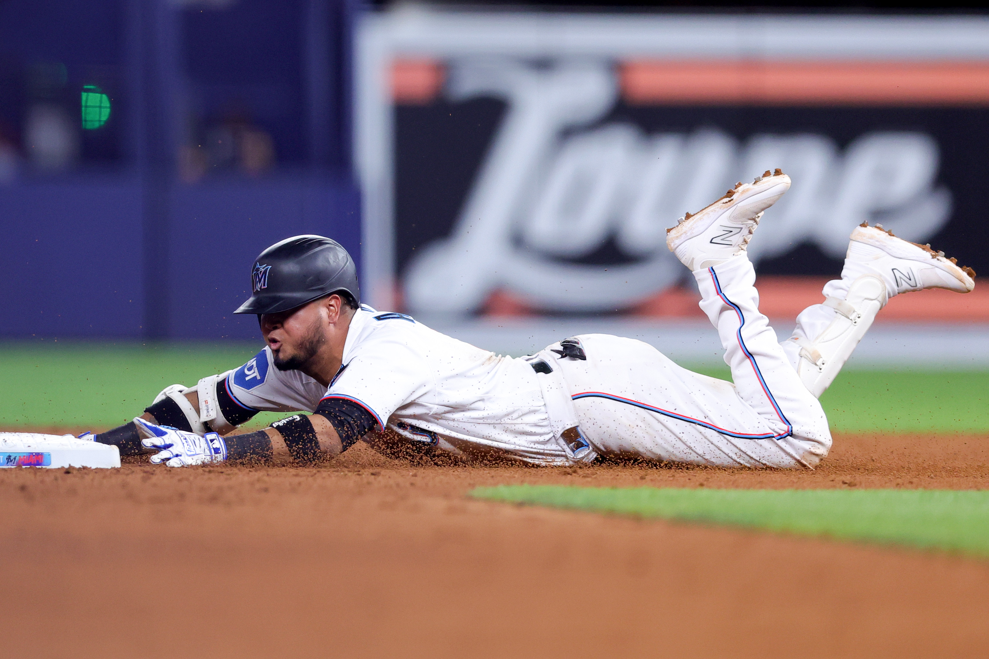 Luis Arraez #3 of the Miami Marlins slides to second base against the Washington Nationals during the eighth inning at loanDepot park on May 17, 2023 in Miami, Florida.