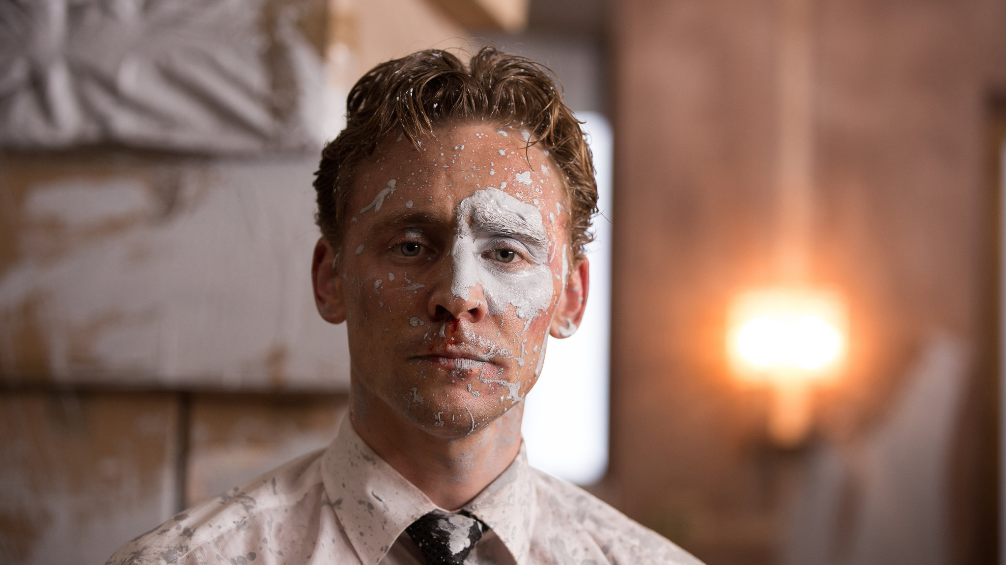 Tom Hiddleston’s face covered in white paint in High-Rise