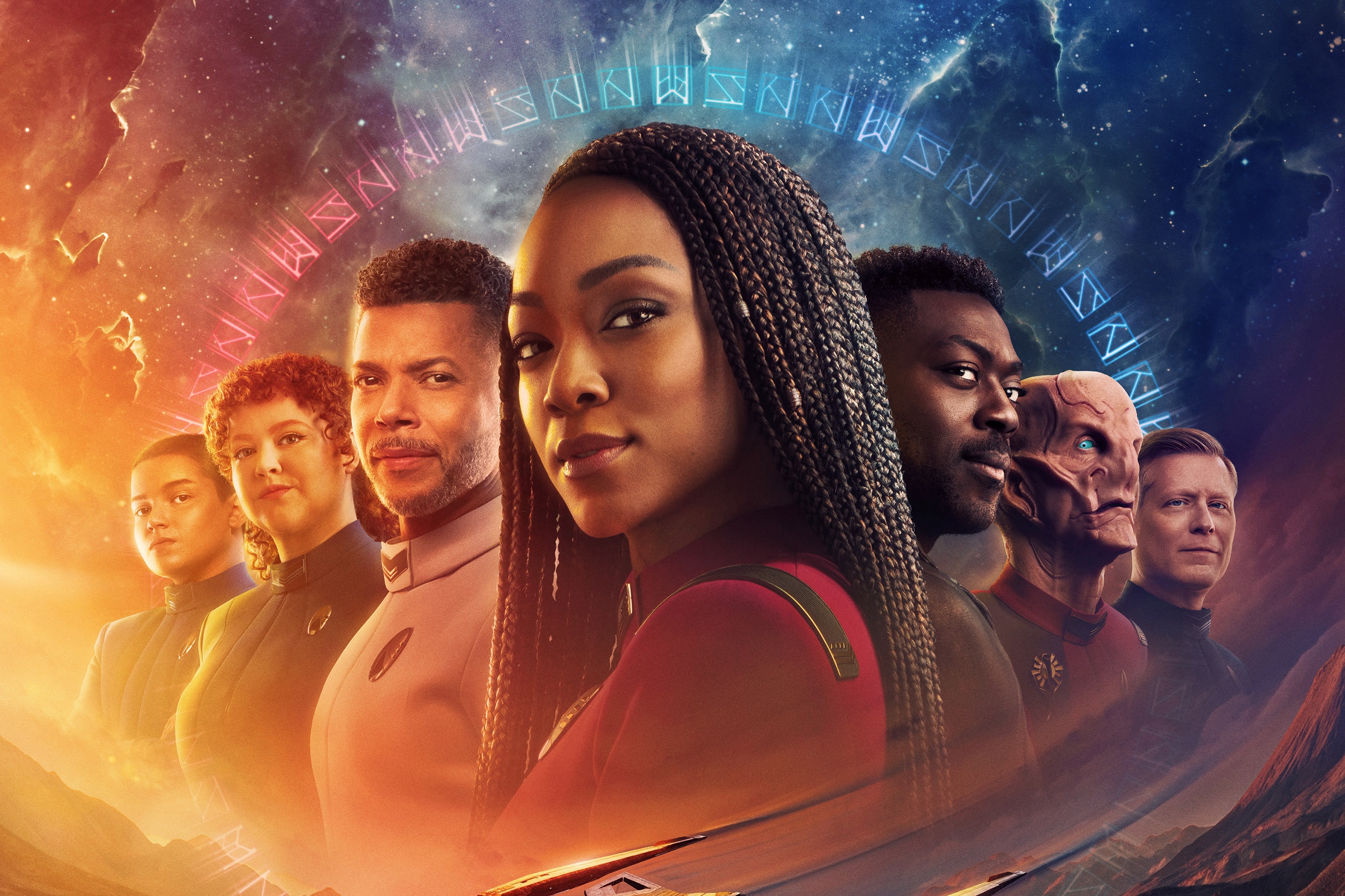 Promotional art for Star Trek: Discovery season 5, featuring a cast lineup surrounded by alien runes. LtR: Blu Del Barrio as Adira, Mary Wiseman as Tilly, Wilson Cruz as Culber, Sonequa Martin-Green as Burnham, David Ajala as Book, Doug Jones as Saru and Anthony Rapp as Stamets.