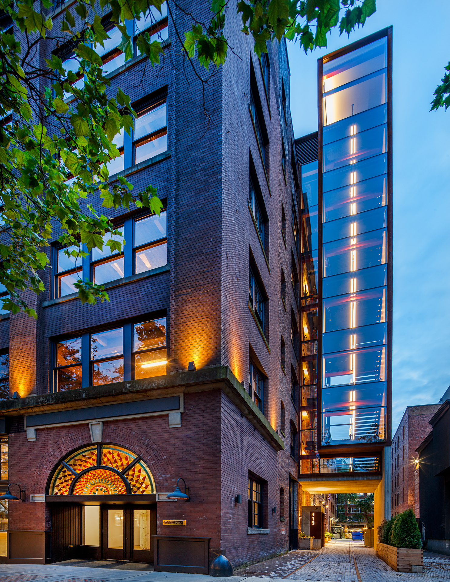 The interior of a modern brick building at twilight.