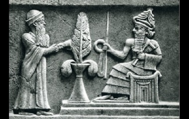 a stone relief of the ancient Babylonian god Enlil sitting on a throne