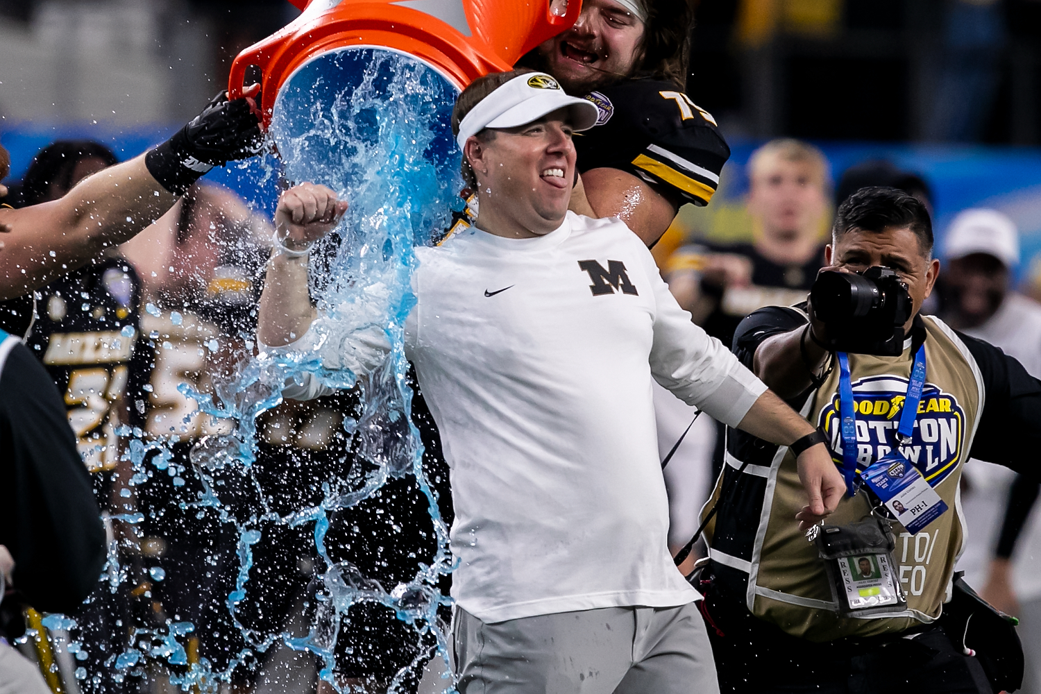 A photo of eli drinkwitz getting dunked with gatorade after winning the 2023 cotton bowl.