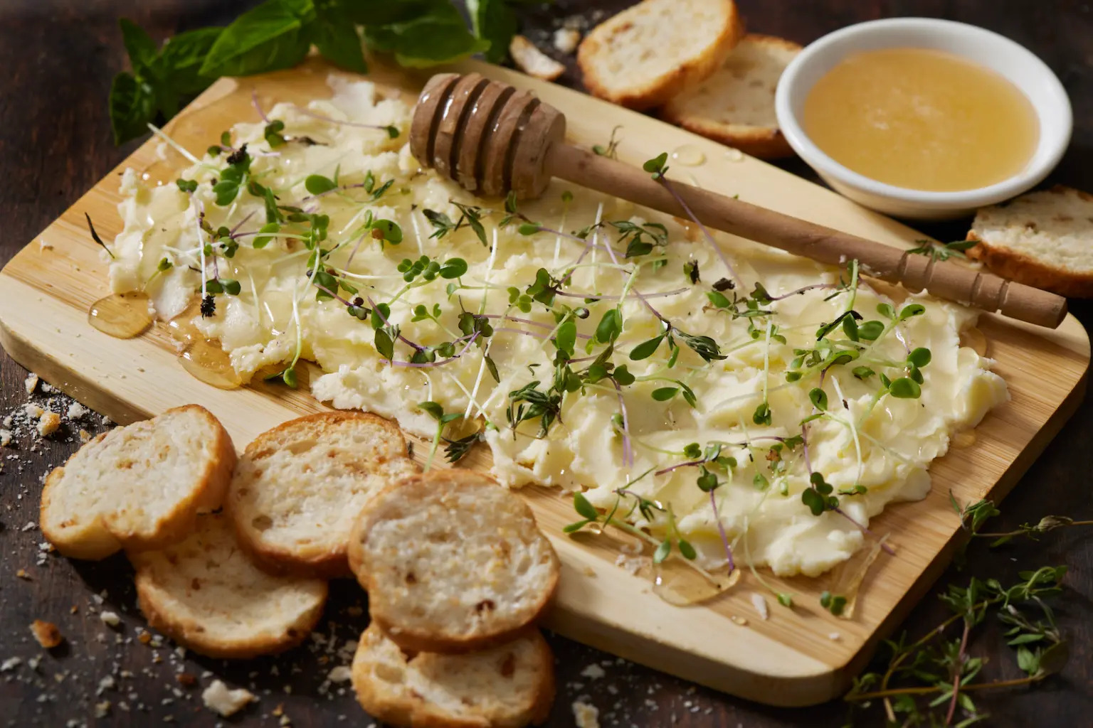 A “butter board,” or a cutting board topped with a layer of butter that has been drizzled with honey and showered with fresh herbs.