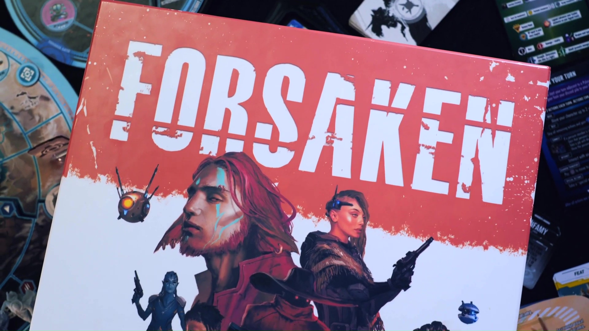 Cover art for the Forsaken board game from Game Trays shows a red-headed mutant man an a female gunslinger.