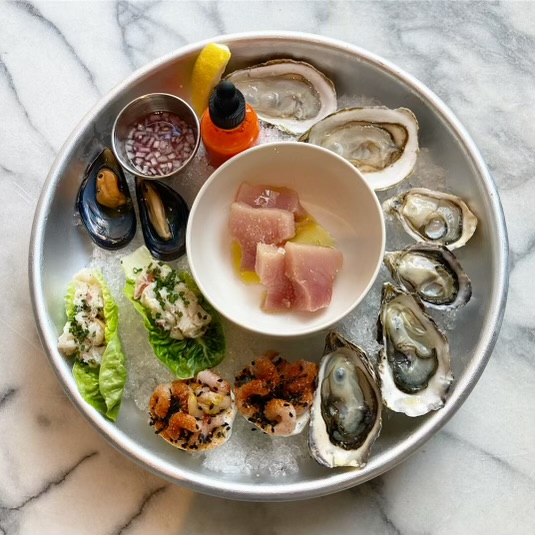 A plate of oysters and various raw seafood. 