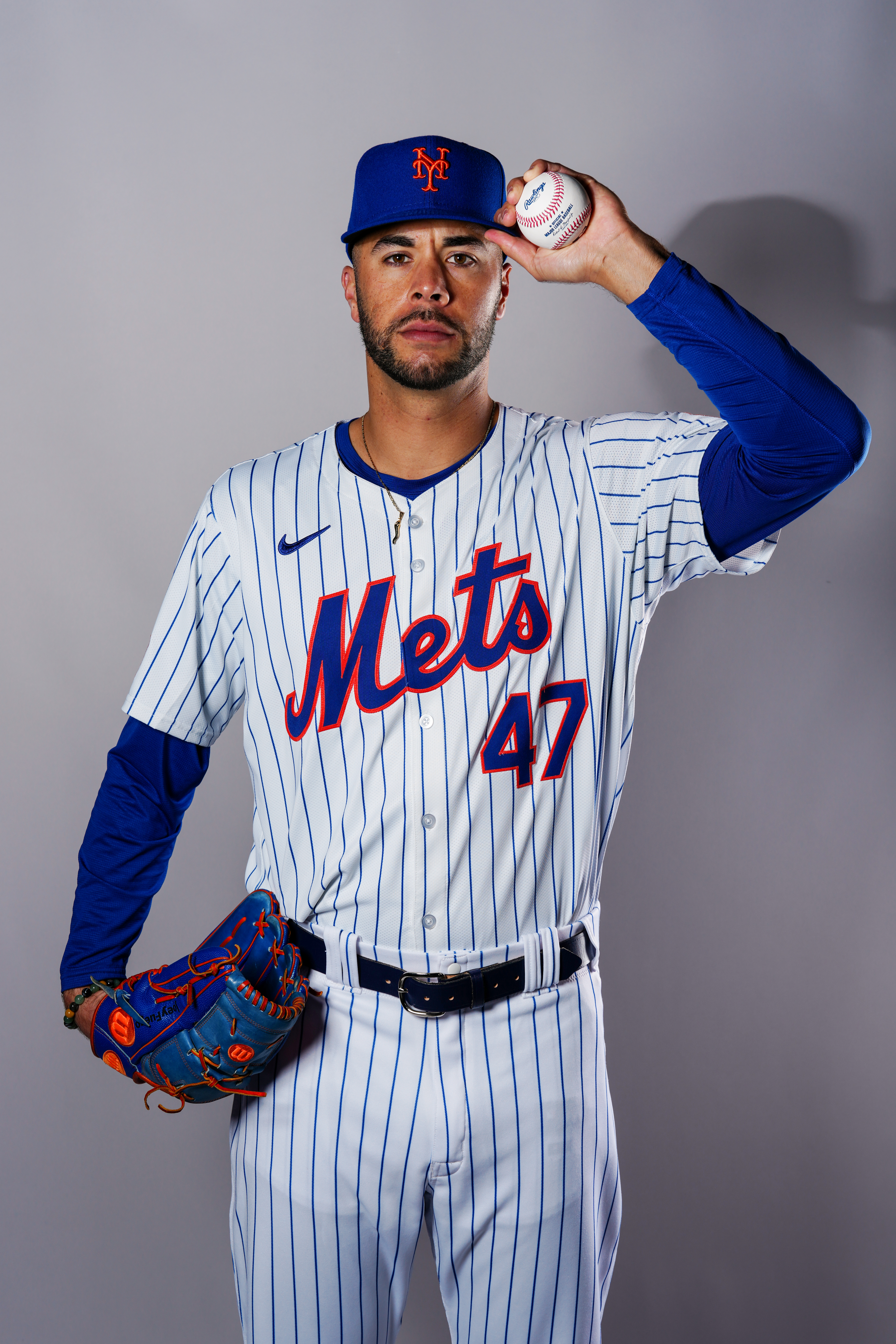 Joey Lucchesi in the Mets’ home uniform on media day, holding his hat with a baseball in his hand.