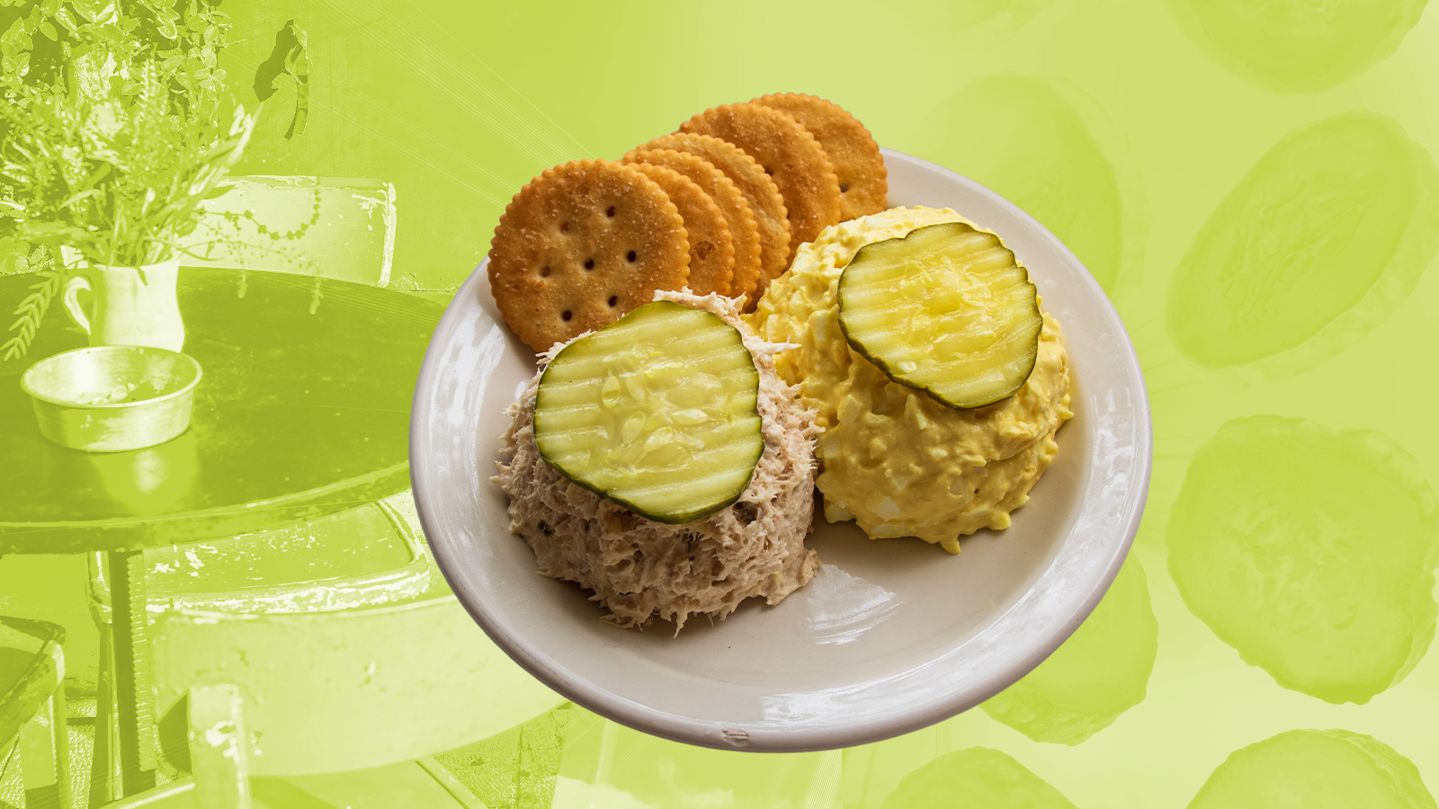 Diner plate containing one scoop of tuna salad and one scoop of chicken salad, each topped with a pickle slice. Ritz-style crackers sit on the plate alongside.