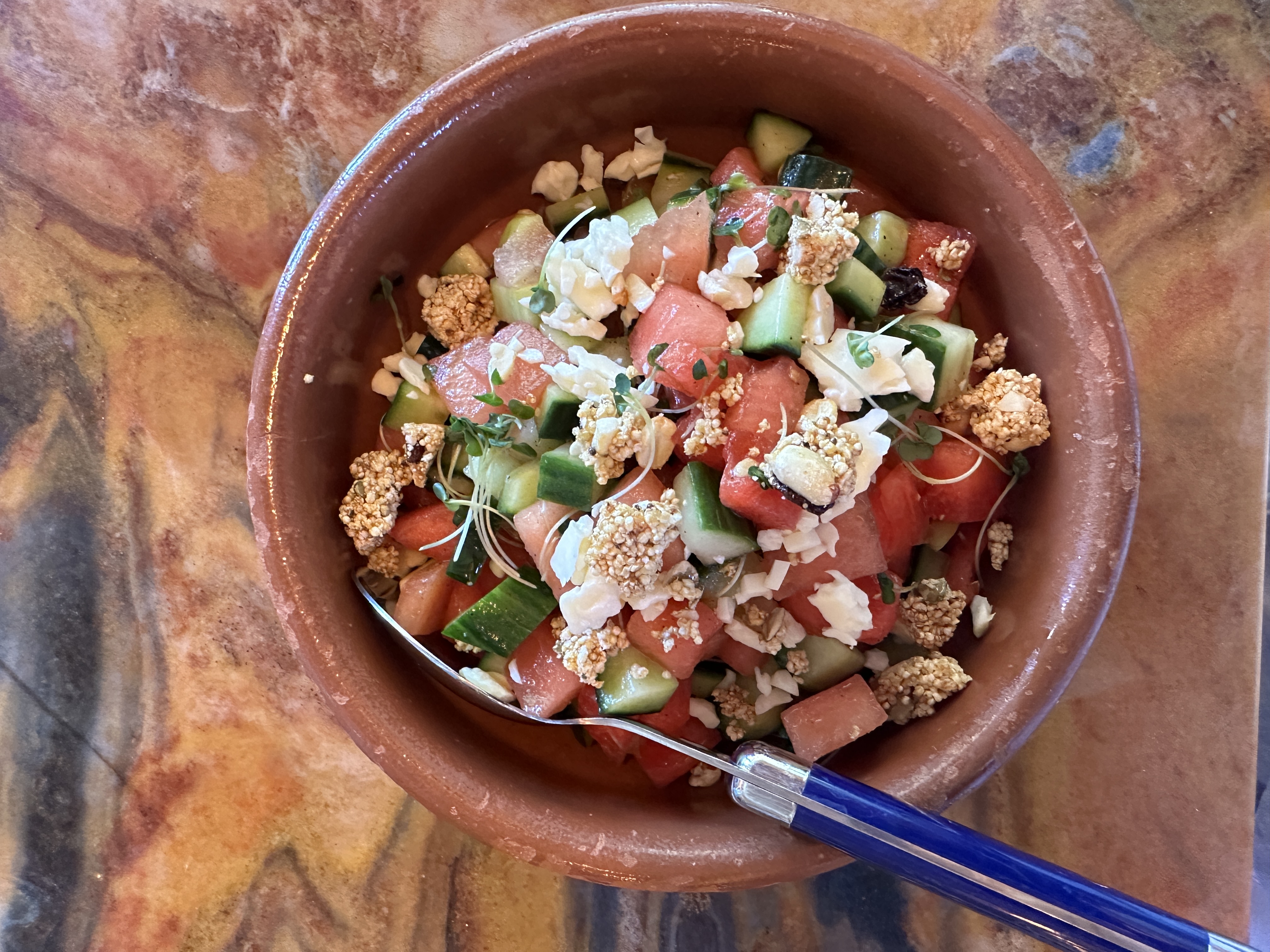 An image of a watermelon salad with cucumber and cotija cheese