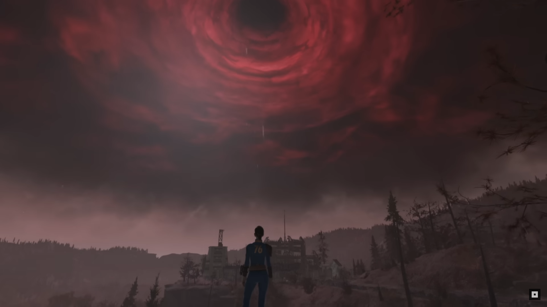 A Vault Dweller from Vault 76 looks up at the ominous sky in Fallout 76’s Skyline Valley, which is a swirling red miasma around a black sun.