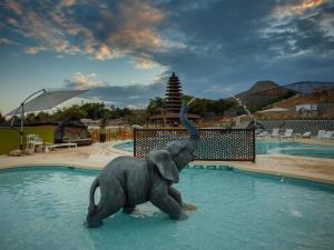 a statue of an elephant standing in the water at Magic Natura Resort in Benidorm