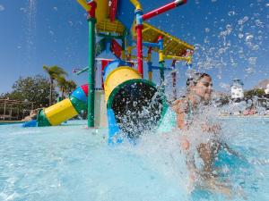 a young child playing in the water at a water park at Magic Natura Resort in Benidorm