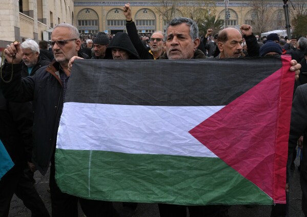 A man holds up a Palestinian flag during a demonstration in which worshippers show their support of Palestinians and condemning the U.S. and British militaries strike against Iranian-backed Houthis in Yemen, after Friday prayer in Tehran, Iran, Friday, Jan. 12, 2024. (AP Photo/Vahid Salemi)