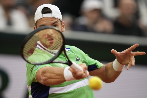 Bulgaria's Grigor Dimitrov plays a shot against Poland's Hubert Hurkacz during their fourth round match of the French Open tennis tournament at the Roland Garros stadium in Paris, Sunday, June 2, 2024. (AP Photo/Christophe Ena)