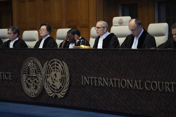 Judge Nawaf Salam, third from right, read the ruling of the International Court of Justice, or World Court, in The Hague, Netherlands, Thursday, May 23, 2024, where Mexico took Ecuador to the United Nations' top court accusing the nation of violating international law by storming into the Mexican embassy in Quito on April 5, and arresting former Ecuador Vice President Jorge Glas, who had been holed up there seeking asylum in Mexico. (AP Photo/Peter Dejong)