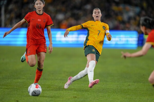 Australia's Steph Catley and China's Wang Yanwen, left, compete for the ball during the women's international soccer friendly between China and Australia at Stadium Australia, in Sydney, Monday, June 3, 2024. (AP Photo/Rick Rycroft)