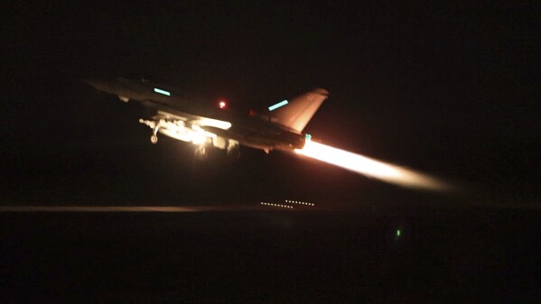 In this image provided by the UK Ministry of Defence taken on Thursday Jan. 11, 2024 shows an RAF Typhoon aircraft taking off from RAF Akrotiri in Cyprus, for a mission to strike targets in Yemen. The U.S. and British militaries bombed more than a dozen sites used by the Iranian-backed Houthis in Yemen late on Thursday, in a massive retaliatory strike using warship- and submarine-launched Tomahawk missiles and fighter jets, U.S. officials said. (Sgt Lee Goddard, UK Ministry of Defence via AP)