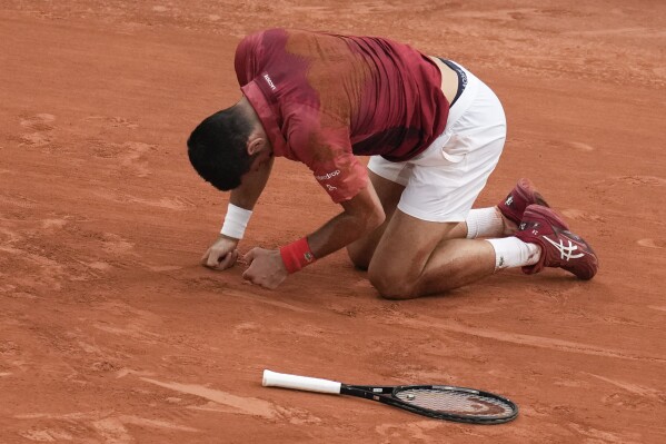 FILE - Serbia's Novak Djokovic slipped and fell during the fourth round match of the French Open tennis tournament against Argentina's Francisco Cerundolo at the Roland Garros stadium in Paris, Monday, June 3, 2024. Novak Djokovic withdrew from the French Open with an injured right knee on Tuesday, June 4, 2024, ending his title defense and meaning he will relinquish the No. 1 ranking. (AP Photo/Christophe Ena, File)