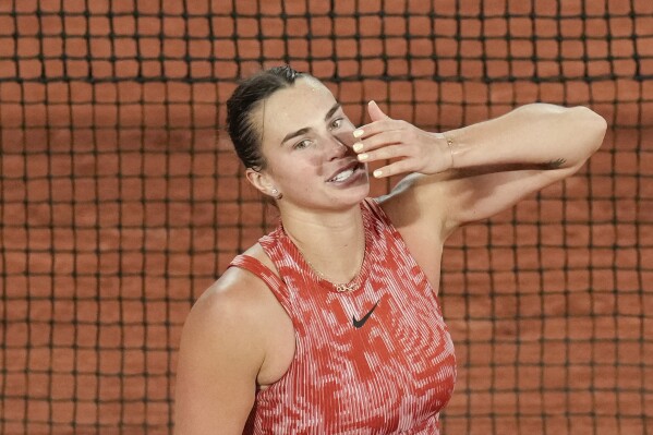 Aryna Sabalenka of Belarus blows a kiss to cheering tennis fans after winning her third round match of the French Open tennis tournament against Spain's Paula Badosa at the Roland Garros stadium in Paris, Saturday, June 1, 2024. (AP Photo/Christophe Ena)