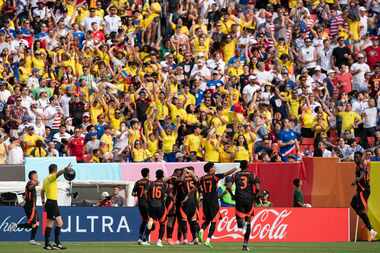 Colombia midfielder Jhon Arias, center with orange cleats, celebrates with his teammates...