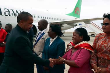 Malawi Vice President Saulos Chilima, left, greets government officials upon his return from...