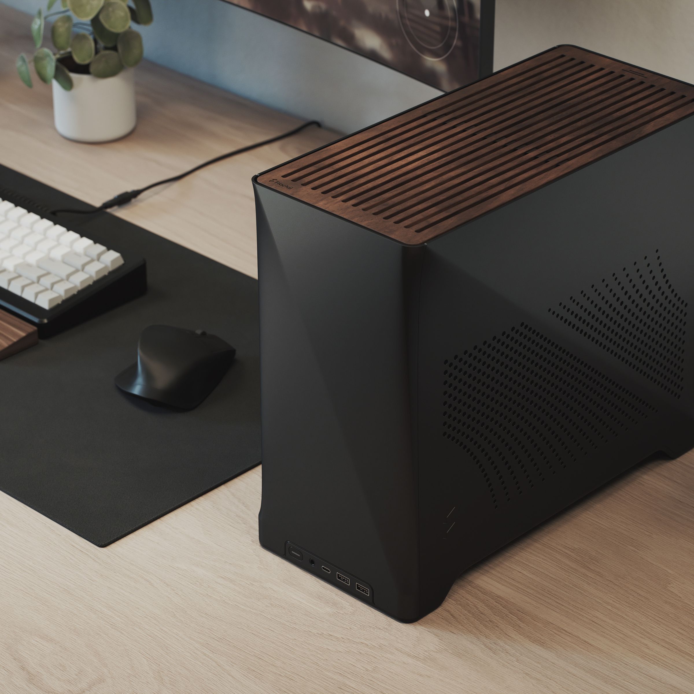 A small desktop PC case with wood paneling on the top next to a keyboard, mouse, and monitor.