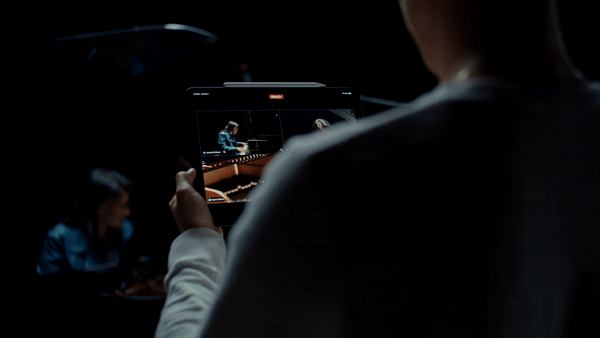 A gif showing a person playing piano and being recorded from multiple angles, with the angles viewable on an iPad.