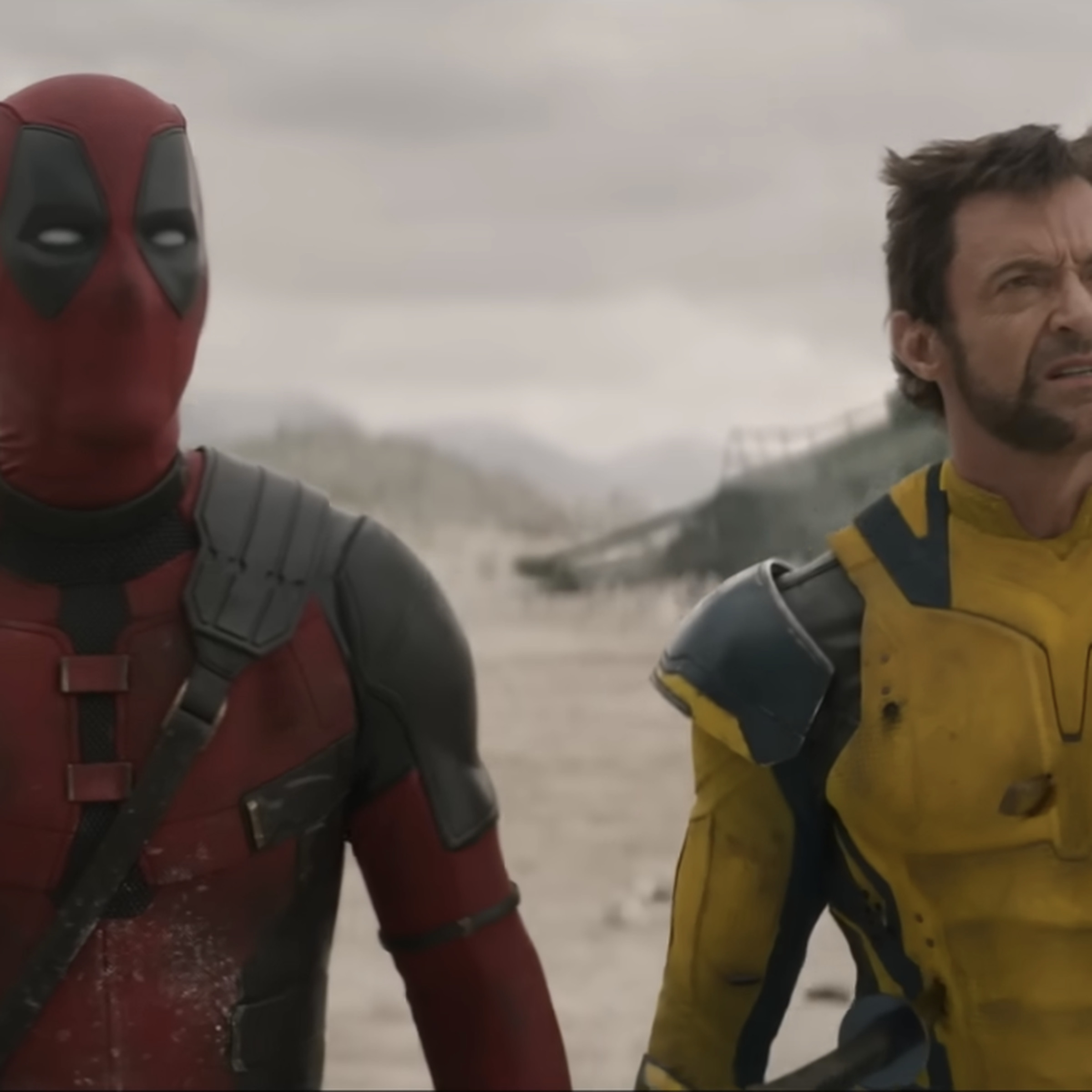 A picture of Deadpool and Wolverine looking upward at something behind the camera.