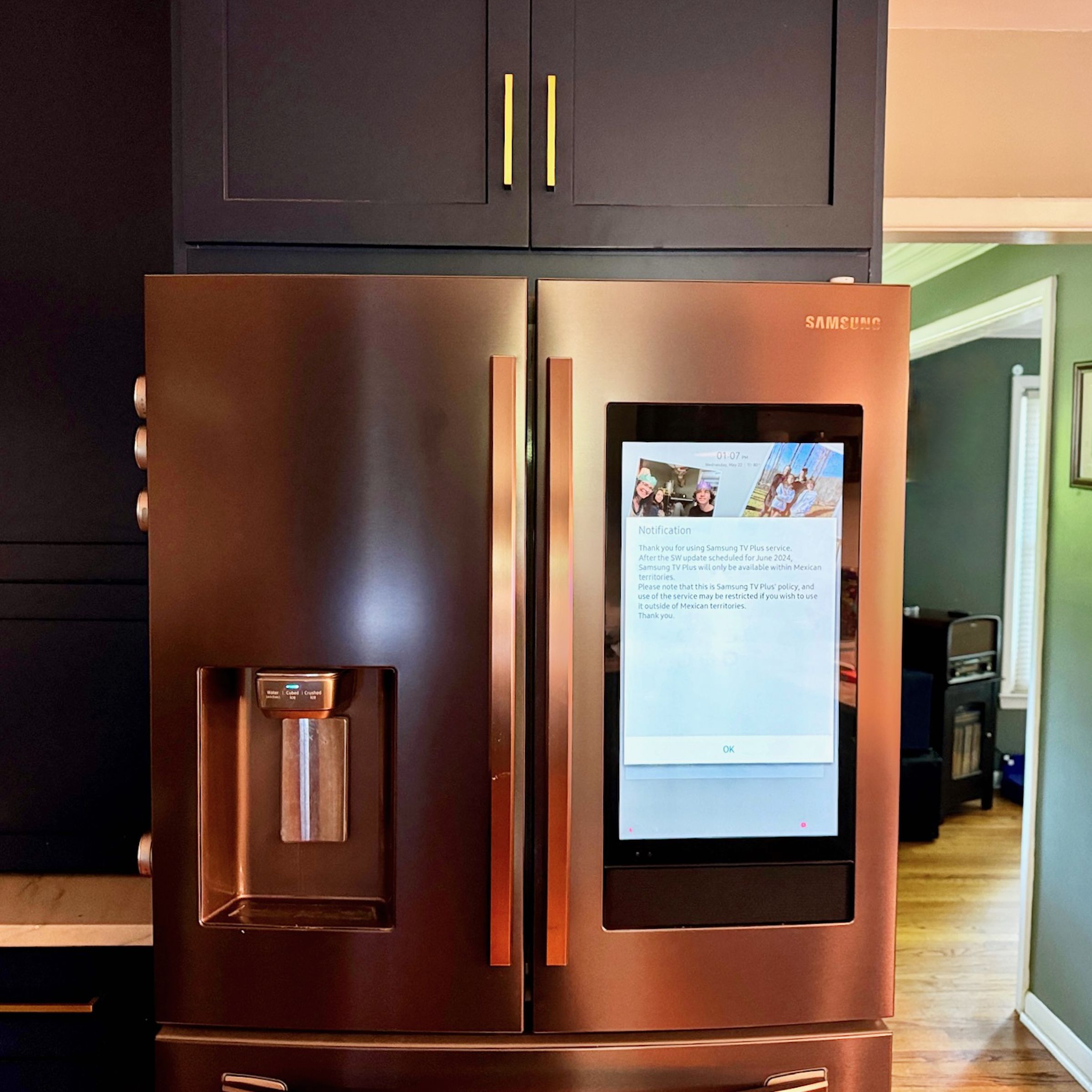 A fridge with a tablet screen in a kitchen.
