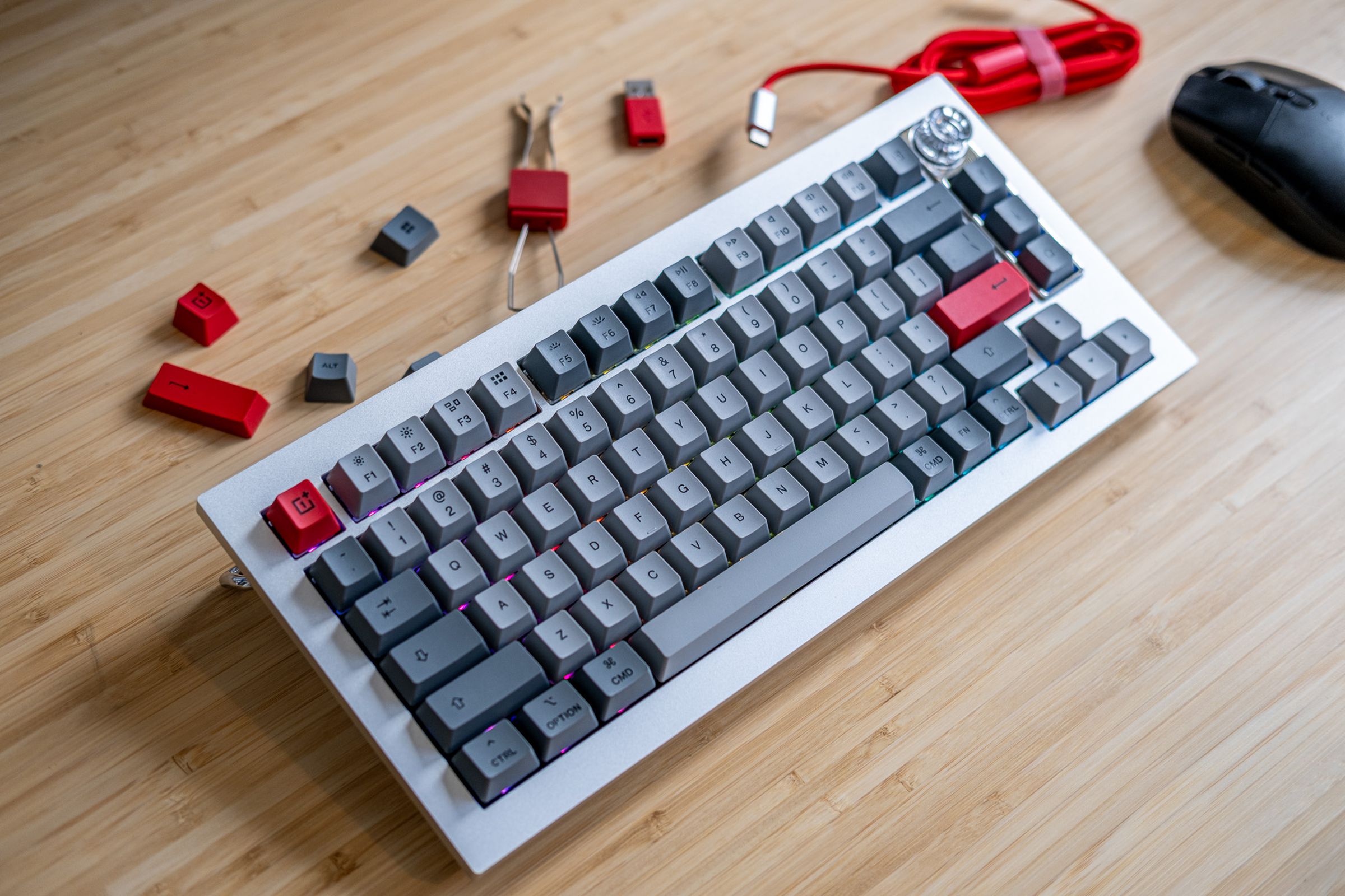 OnePlus keyboard on desk surrounded by accessories.
