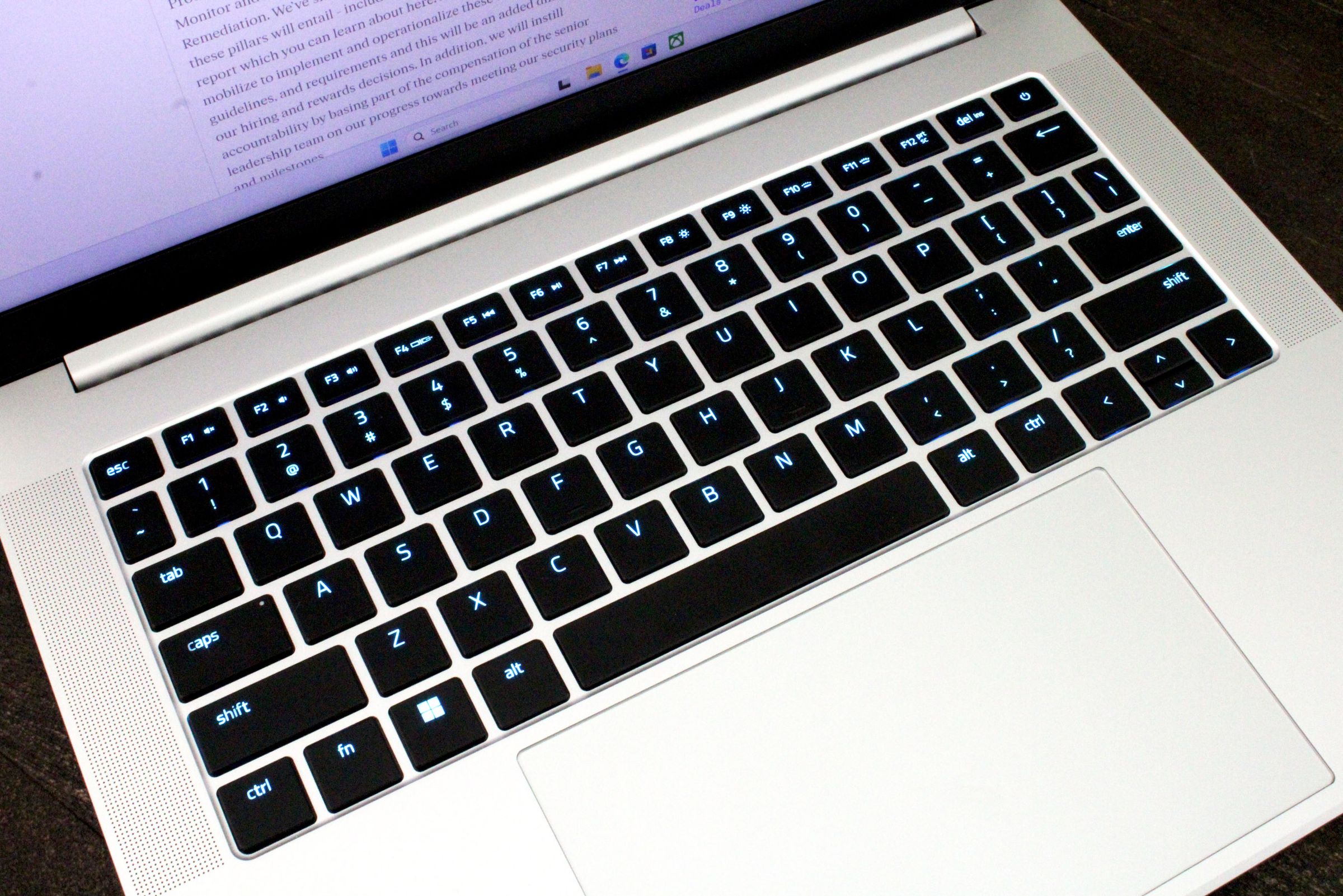 A close-up of a laptop keyboard with black keys and a silver chassis.