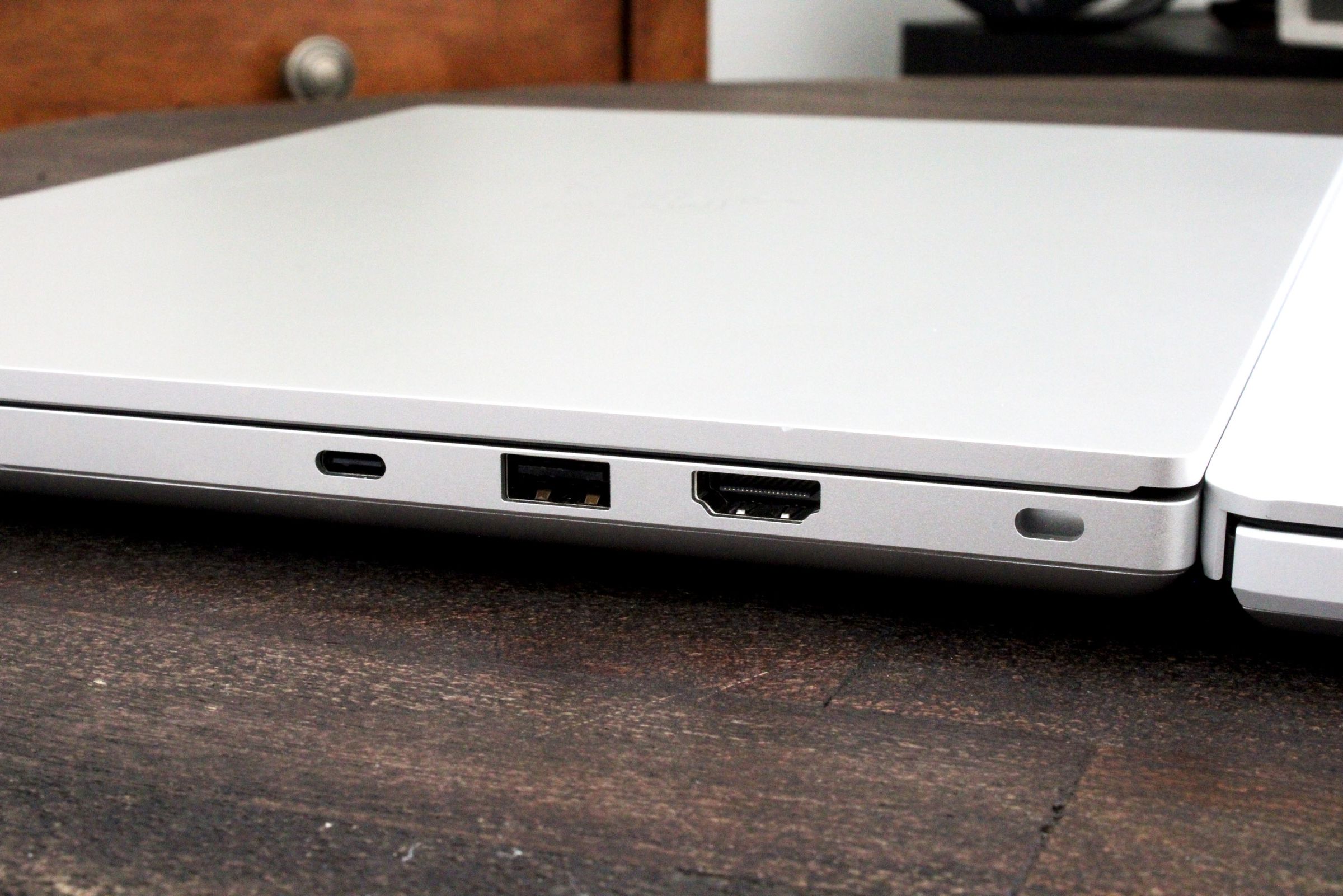 A close-up of a few connectivity ports on the side of a silver laptop.