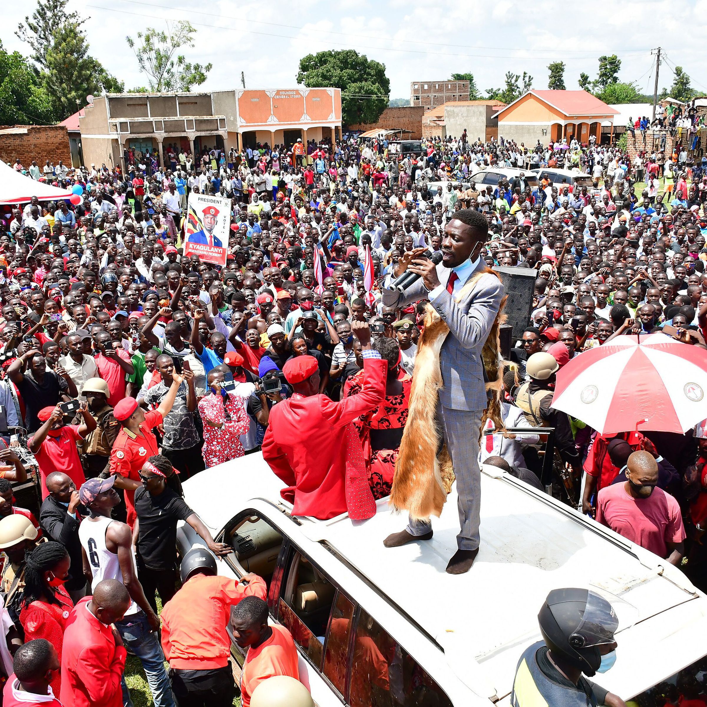 Robert Kyagulanyi Ssentamu (standing on roof of the vehicle), a candidate in Uganda’s general elections in 2021 and widely regarded as the closest challenger to incumbent Yoweri Museveni, campaigns in Butaleja district in the country’s East on November 17, 2020.