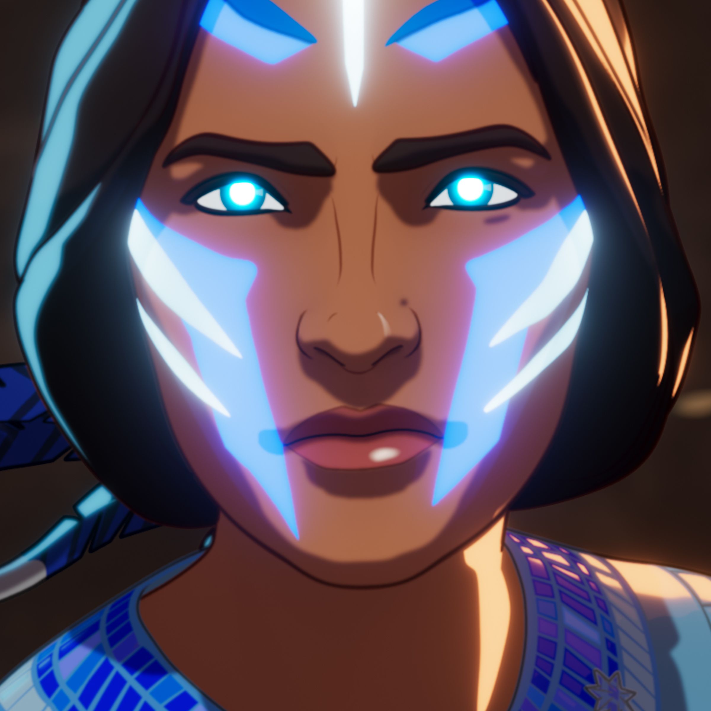A tight shot of a young Native American woman whose face is adorned in glowing blue and white markings.