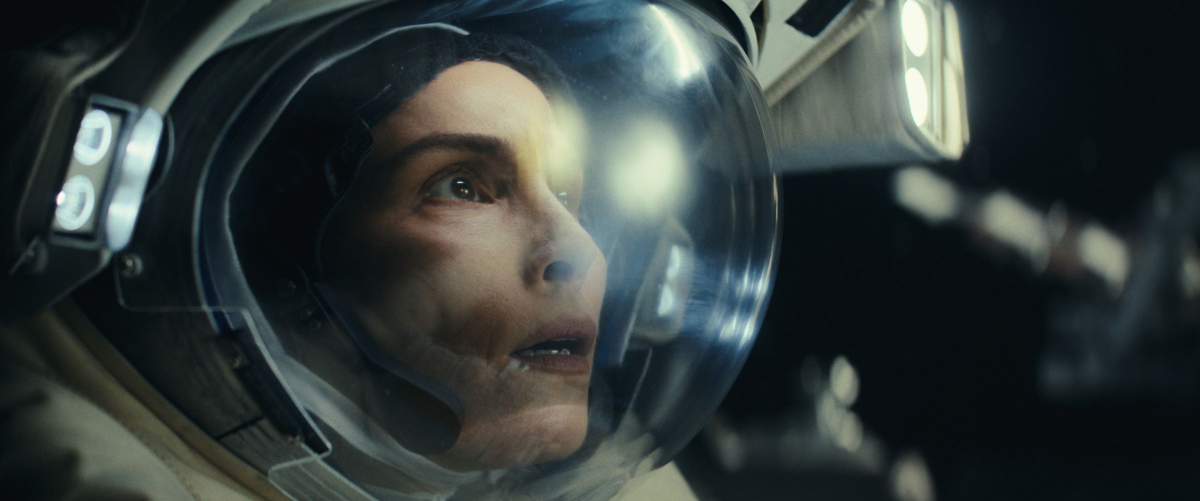 Picture of Noomi Rapace wearing an astronaut’s helmet, looking at something anxiously&nbsp;in a scene from the sci-fi TV series Constellation.