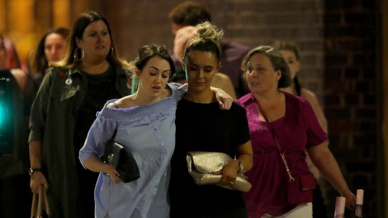 Police escort members of the public from Manchester Arena after and explosion at Ariana Grande gig