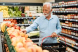 senior man grocery shopping GettyImages-1383004162