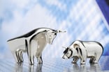 A platinum metal figurine bull and bear face off.